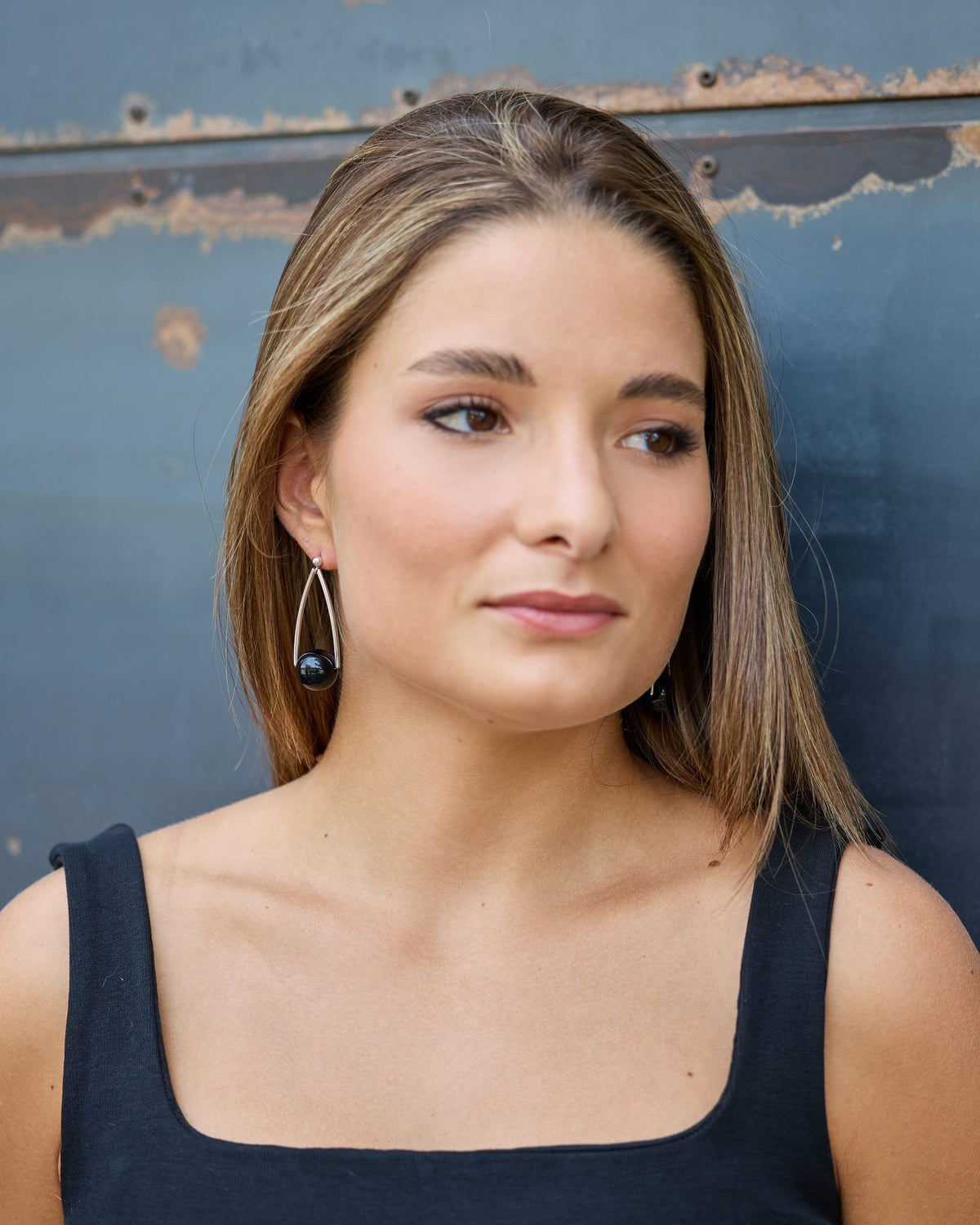 Woman wearing Uno due tre Earrings