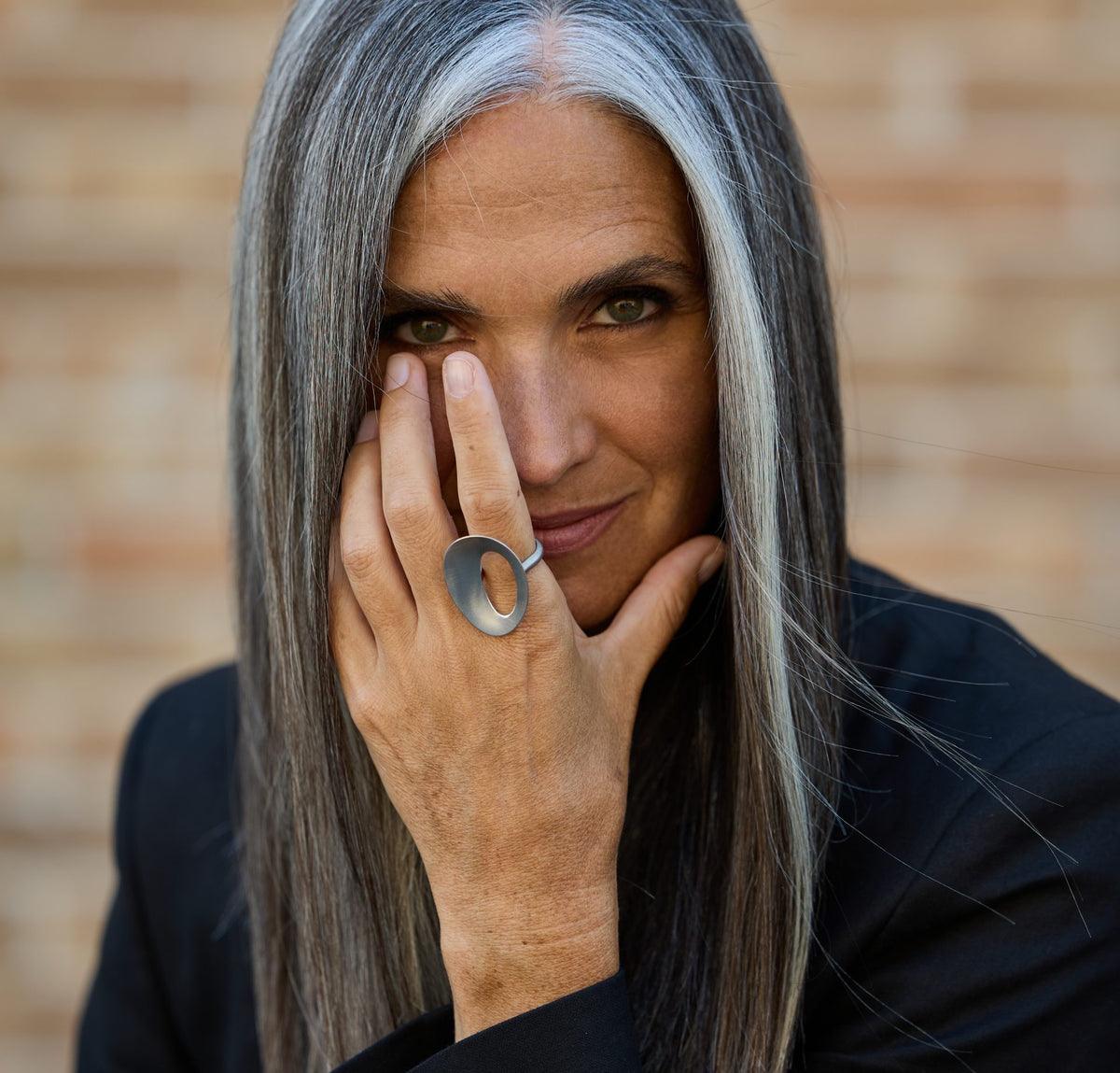 Woman wearing an Ellesanti ring, her hand near her face