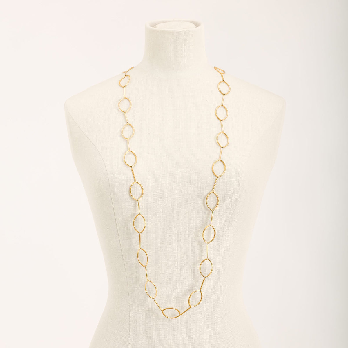 Collana Aurora Oro in tubini di ottone dorato satinato, su fondo chiaro