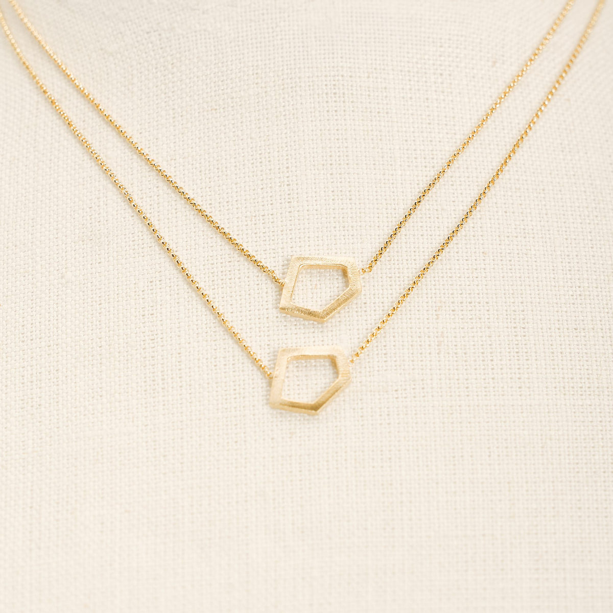 I'mperfect Gold necklace in 925 sterling silver, on a light background