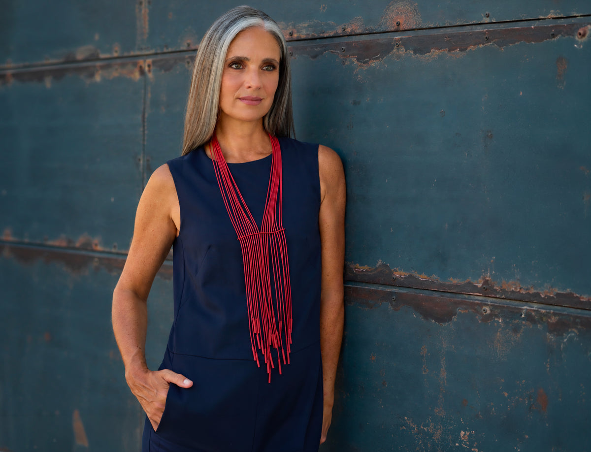 Donna con la collana Niagara rosso pastello