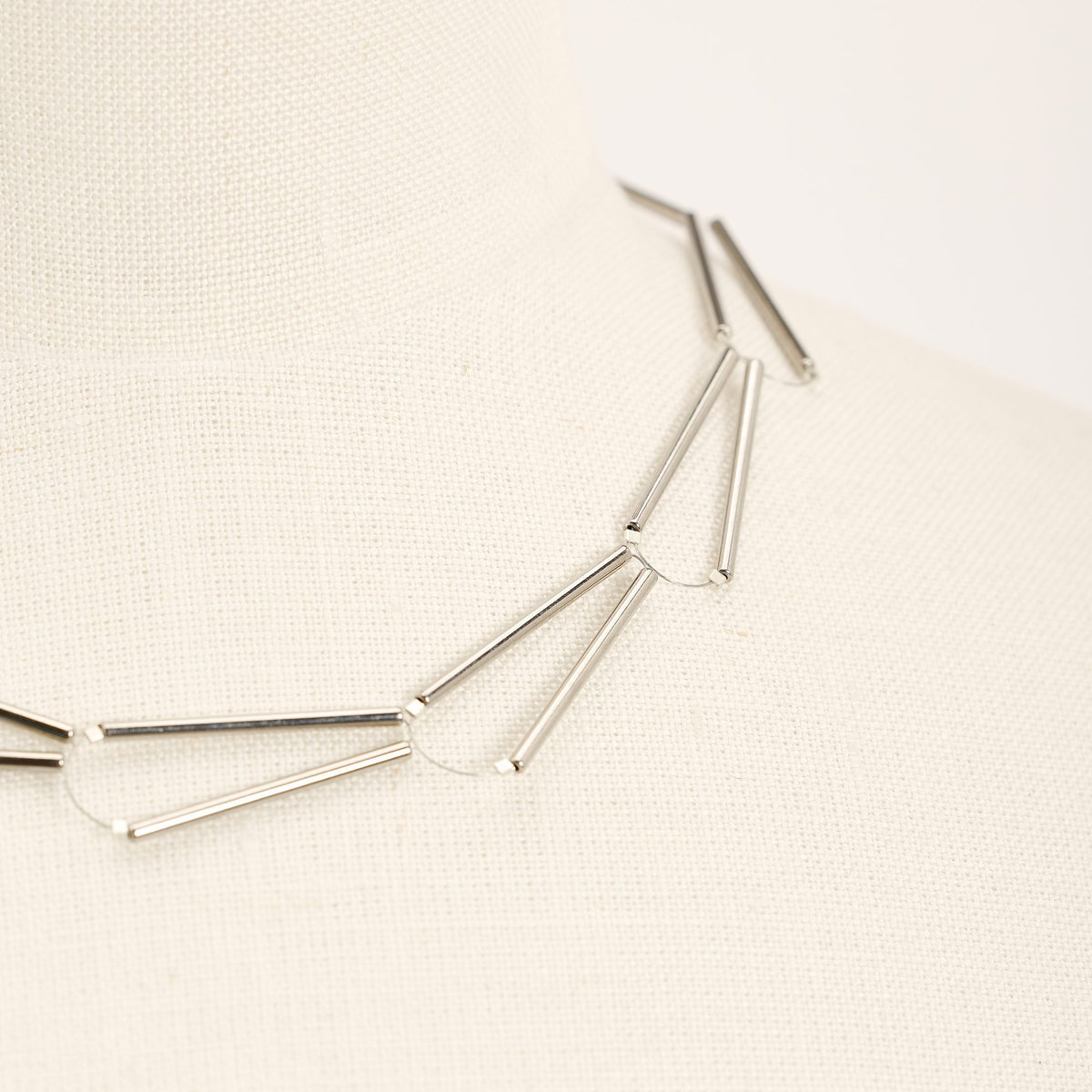 Parentesi Rhodium necklace in rhodium-plated brass with silver clasp, close-up detail on a light background