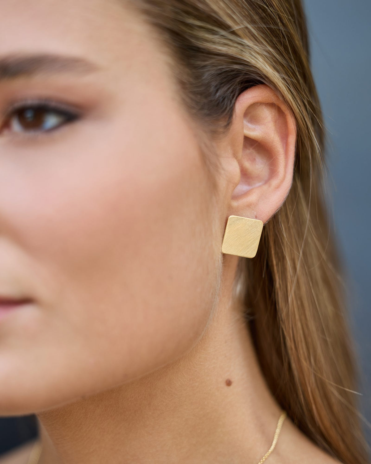 QB Gold earrings in 925 sterling silver, worn