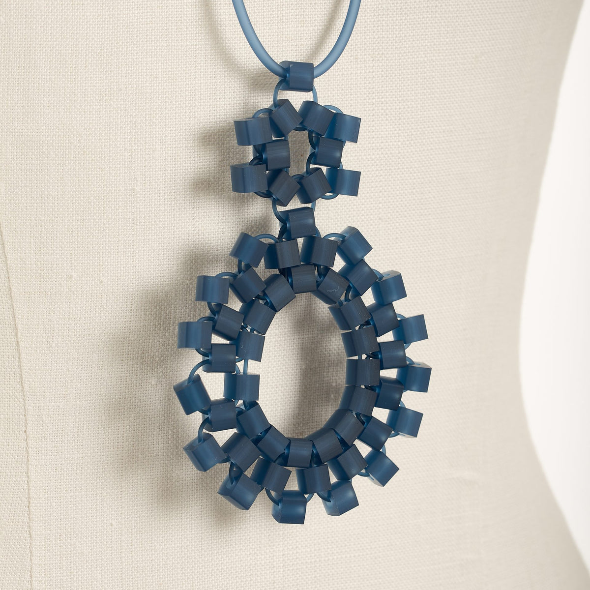 Block 2 necklace in blue on a bust