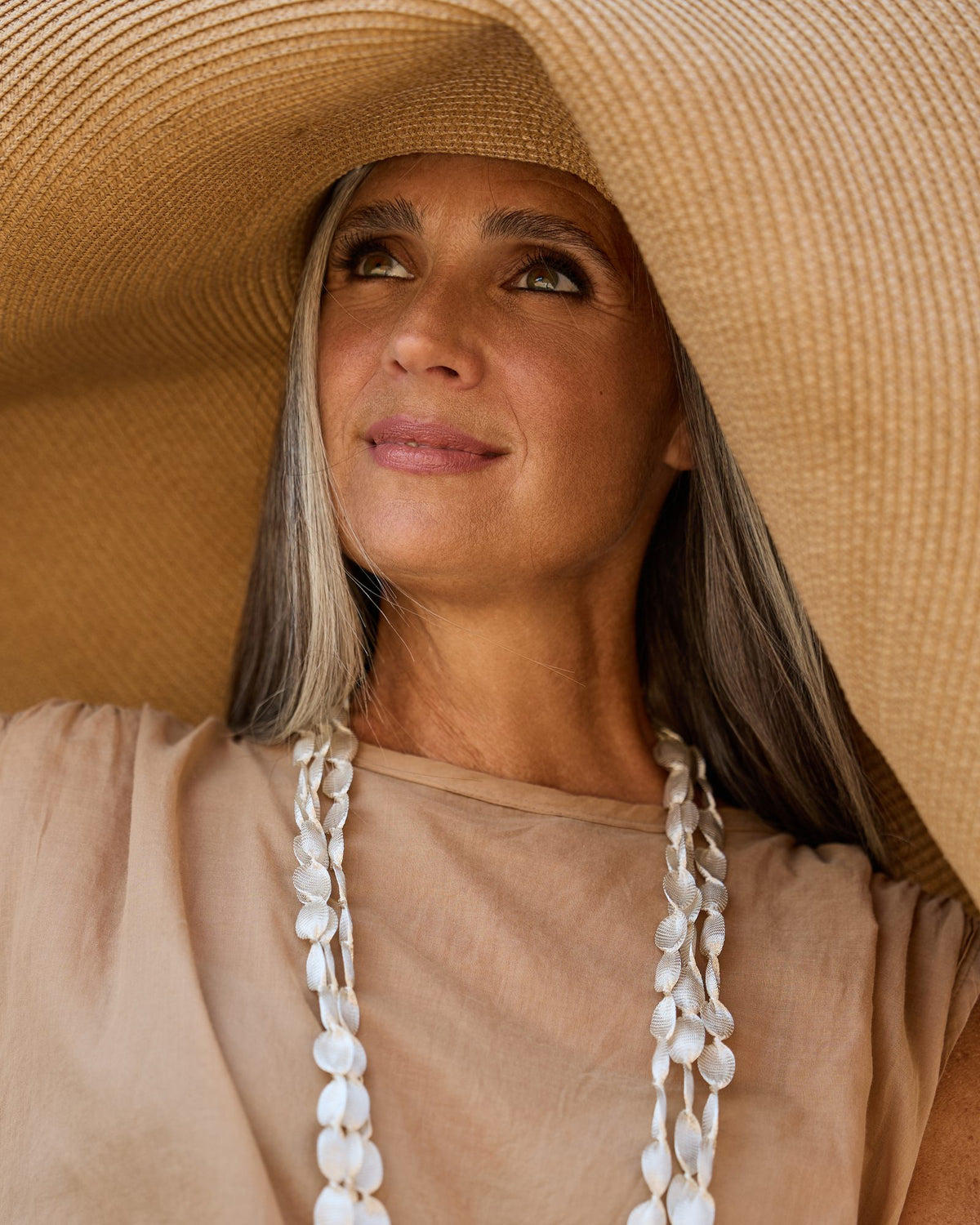 Woman wearing Caurì Long Necklace