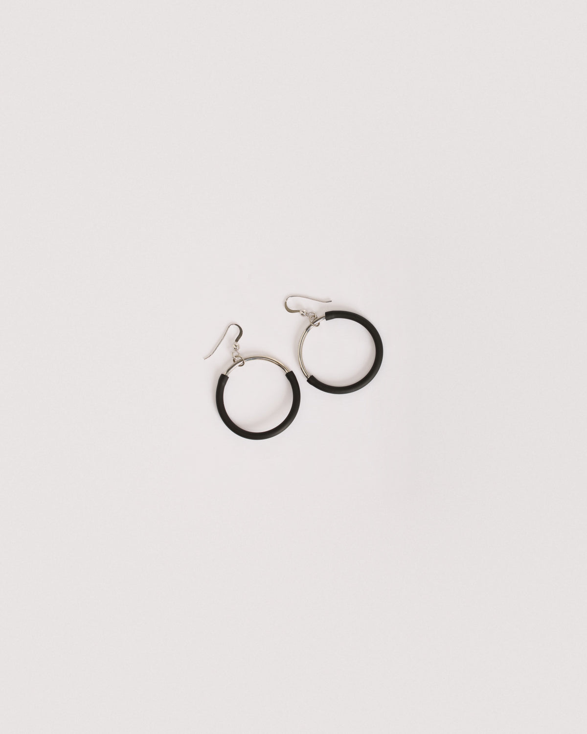 Woman wearing Eclissi Rhodium Earrings