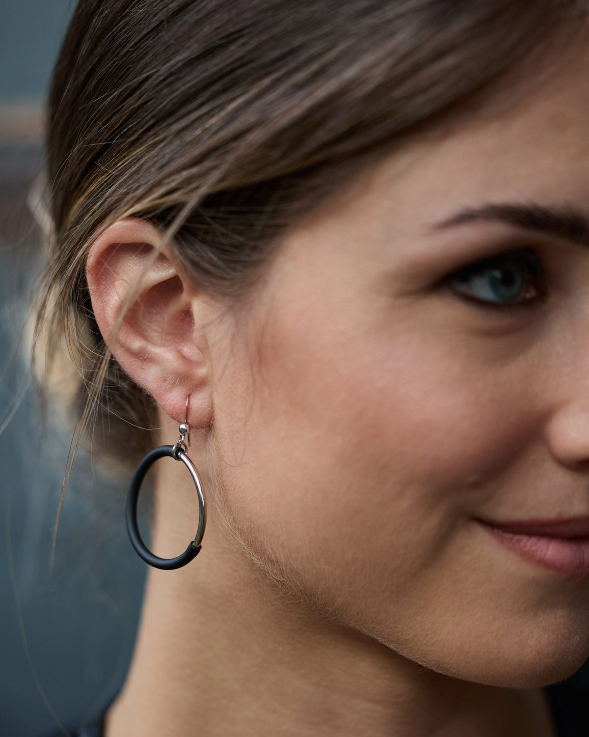 Woman wearing Eclissi Rhodium Earrings