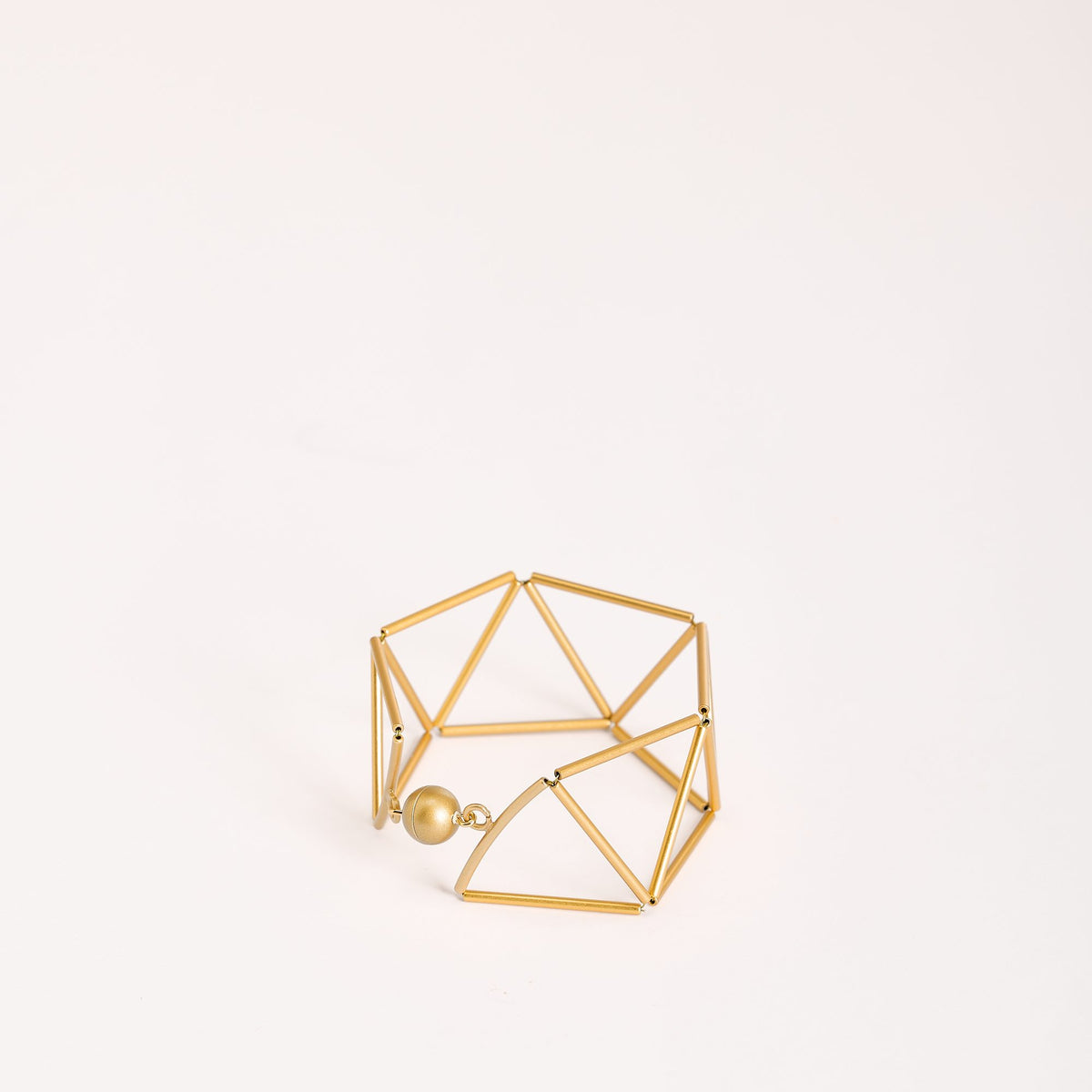 Greca Gold bracelet in gold-plated brass, on a white background