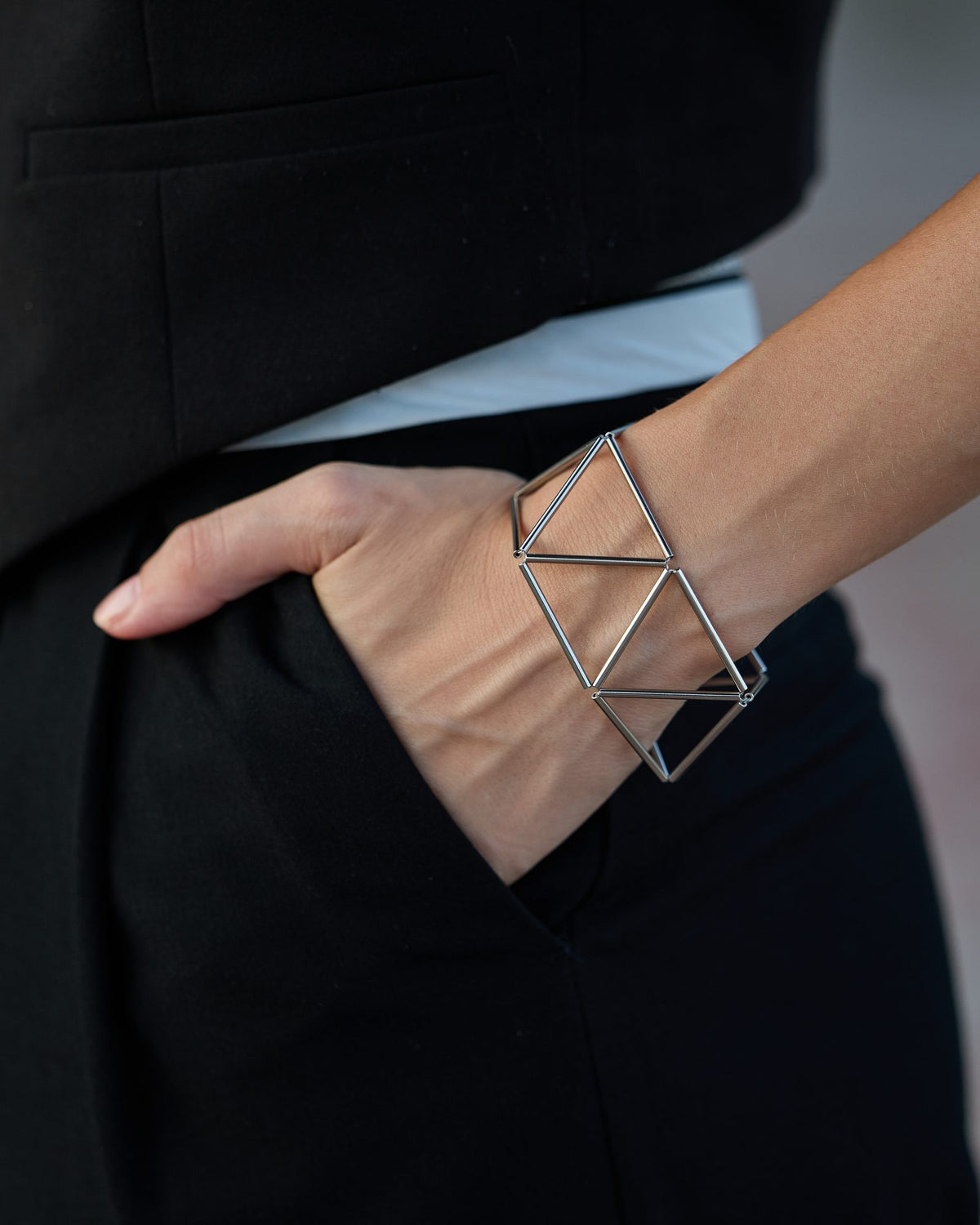 Greca Rhodium bracelet in rhodium-plated brass, worn, close-up on the wrist