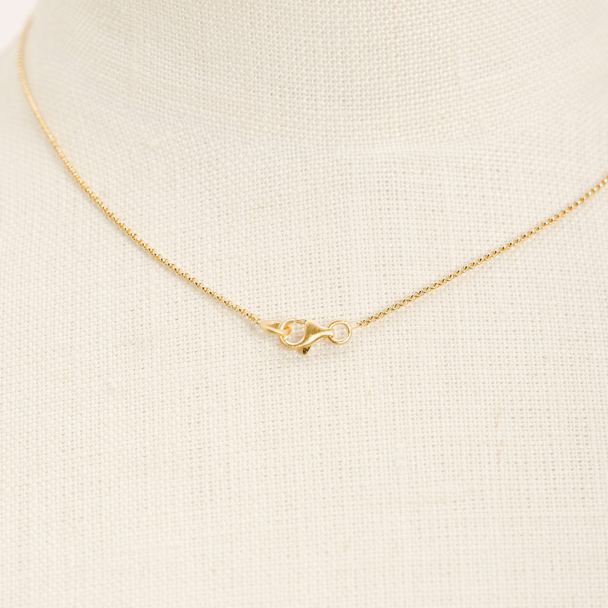 I'mperfect Gold necklace in 925 sterling silver, close-up detail on a light background