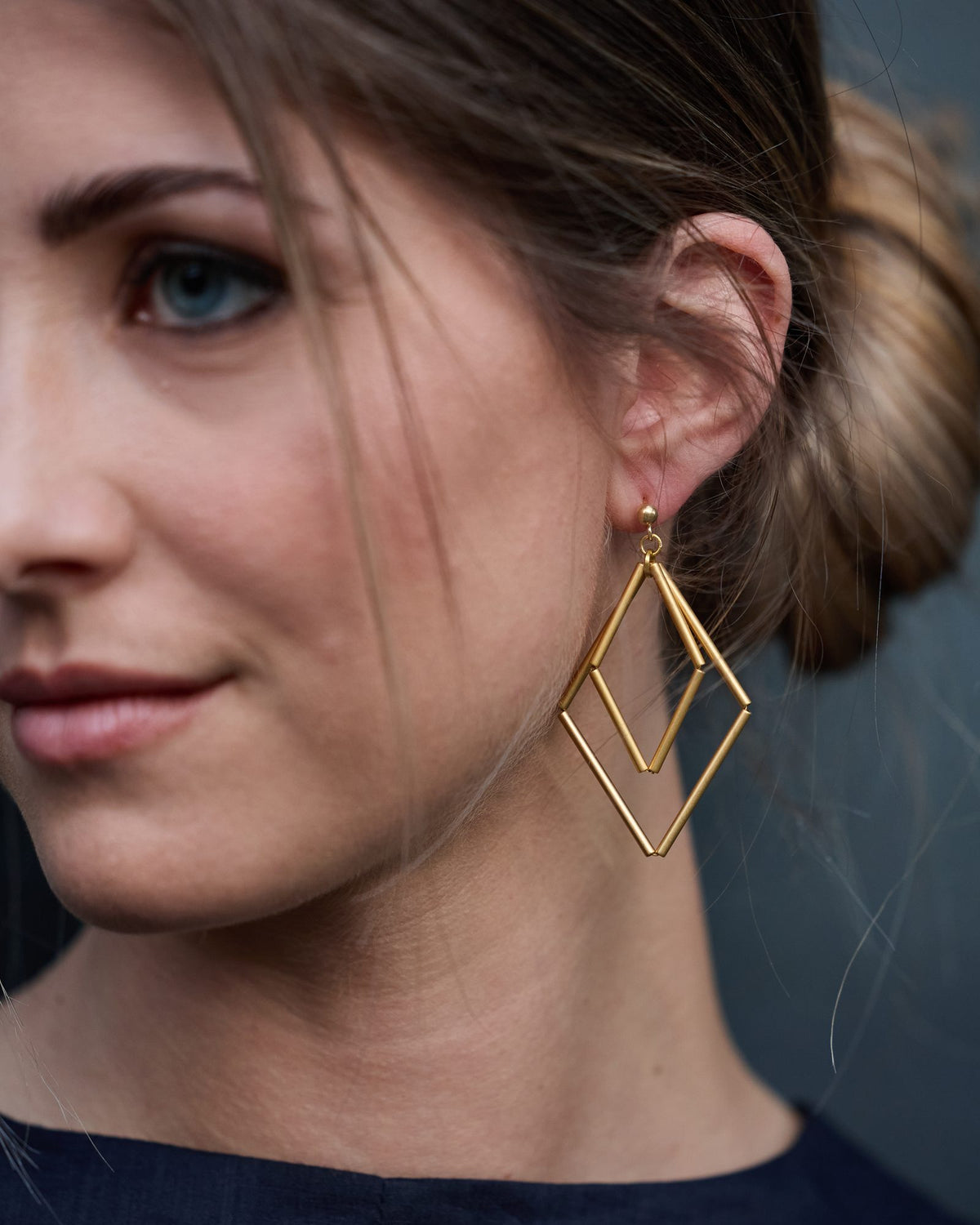 Paloma Gold earrings in gold-plated brass and silver, worn, close-up on the ear