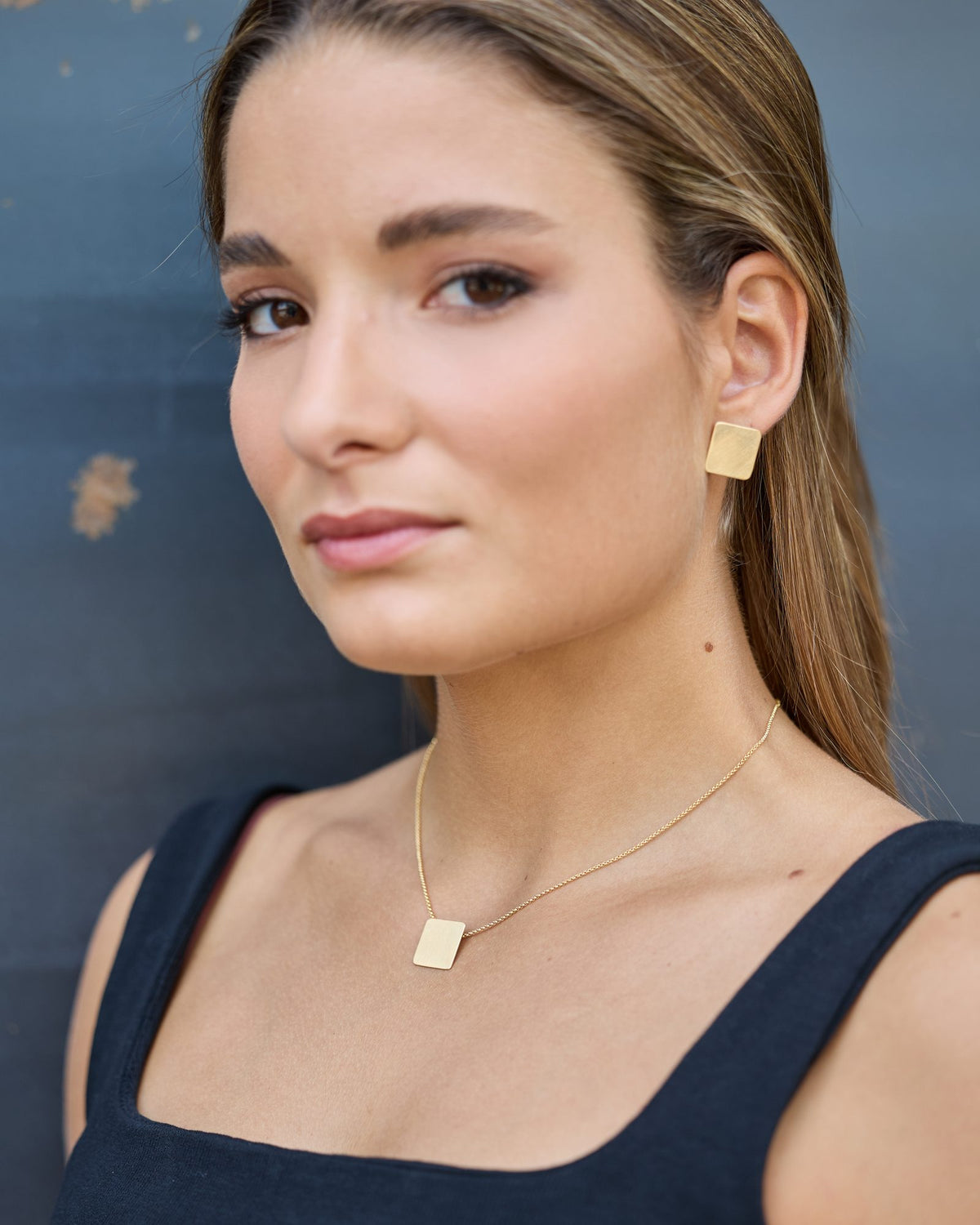 QB Gold earrings in 925 sterling silver, worn