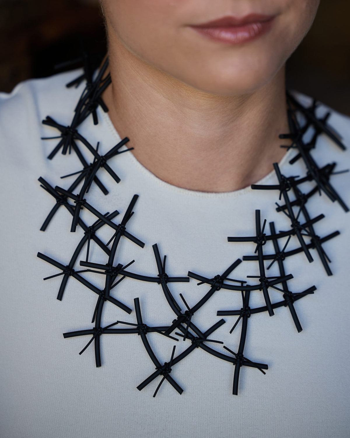 Woman wearing X Necklace